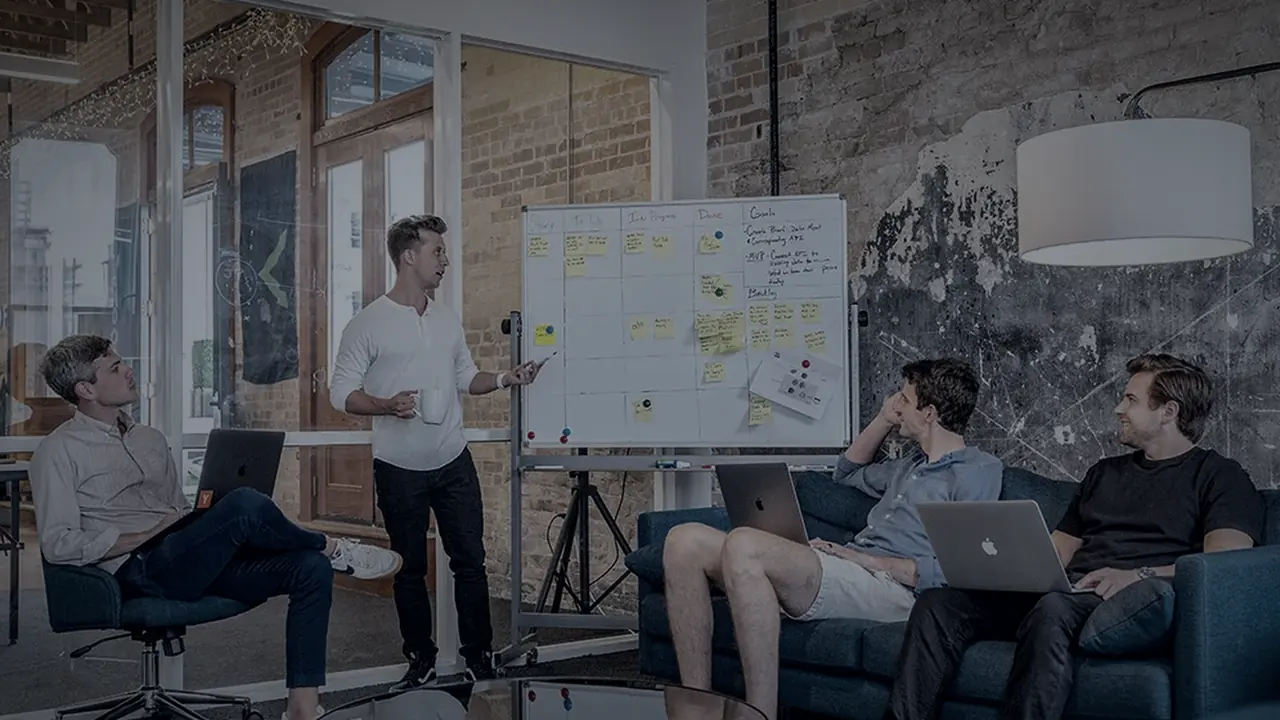 A project team reviewing a planning board in a meeting room